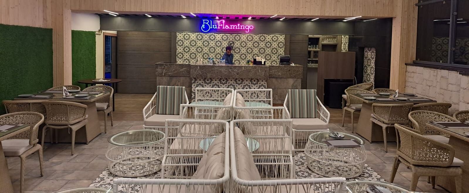Rooftop lounge featuring illuminated Blu Flamingo logo with ambient lighting at BluSalzz Residence, Amritsar